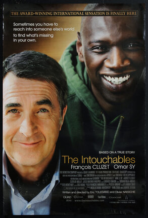 movie poster with one white man (François Cluzet) and one black man (Omar Sy) both smiling.