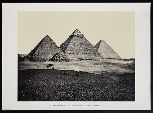 a photograph of three pyramids in the desert