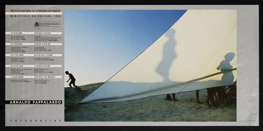 poster with a schedule of events and close-up photograph of a white sail on a beach.