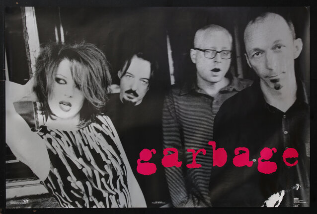 poster with black and white photo of a four person rock band