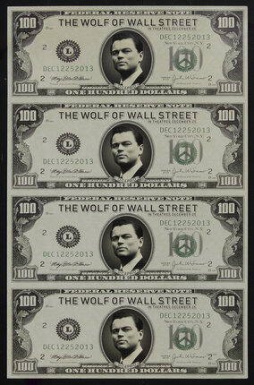 Poster with four U.S. 100 dollar bills with Leonardo DiCaprio's face on the bills.
