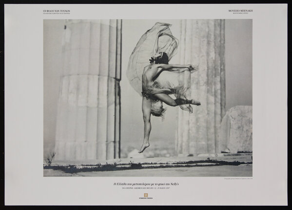 photograph of a topless woman leaping in dance with sheer veils