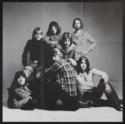 poster with the photograph of 7 men posing together