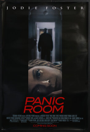 movie poster with a woman's face in the horizontal position and a shadowy figure in the background