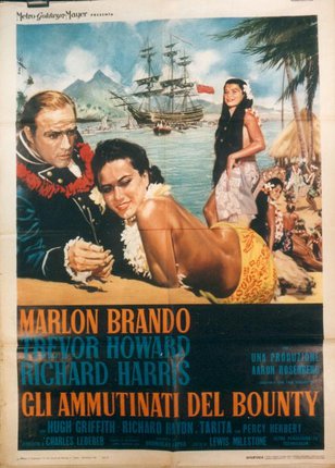 a movie poster of a man and a woman on a beach