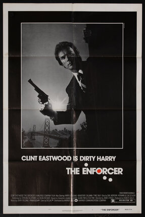 a movie poster of a man (Clint Eastwood) holding a gun with the San Francisco Golden Gate Bridge in the background