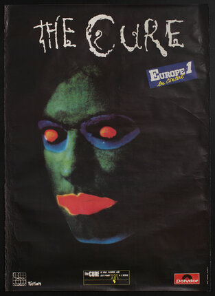 poster with a green face with red lips and red glowing eyes