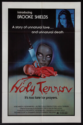 a poster of doll with a knife in it's back, blood flowing out of it and and a mask with glowing eyes behind it. 