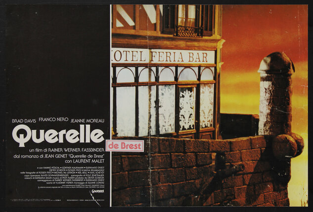 movie poster of the outside window of a hotel bar with a phallic stone structure jutting from a brick wall