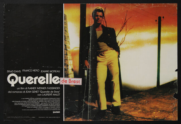 movie poster of a man in a sailor costume leaning agains a telephone pole