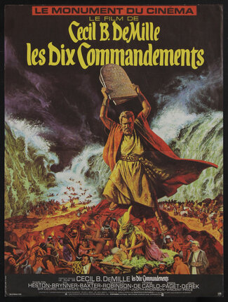 movie poster with Moses holding up stone tablet while the sea parts behind him