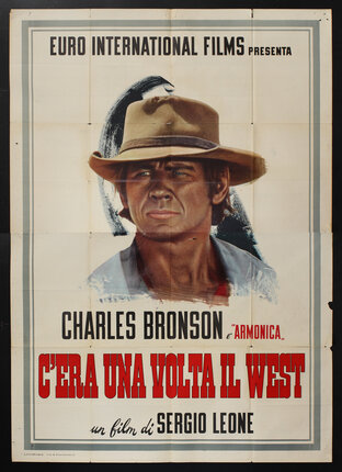 a poster of a man (Charles Bronson) wearing a hat.