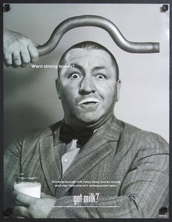 a man holding a milk tube over his head