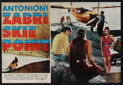 a group of people sitting on rocks looking at a plane