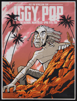 concert poster with a man (Iggy Pop) crawling out of rocks with palm trees behind him