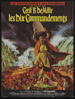 movie poster with Moses holding up stone tablet while the sea parts behind him